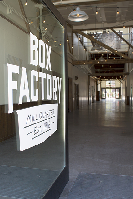 Looking into the breezeway at the Box Factory - the store's logo is painted on the glass doors